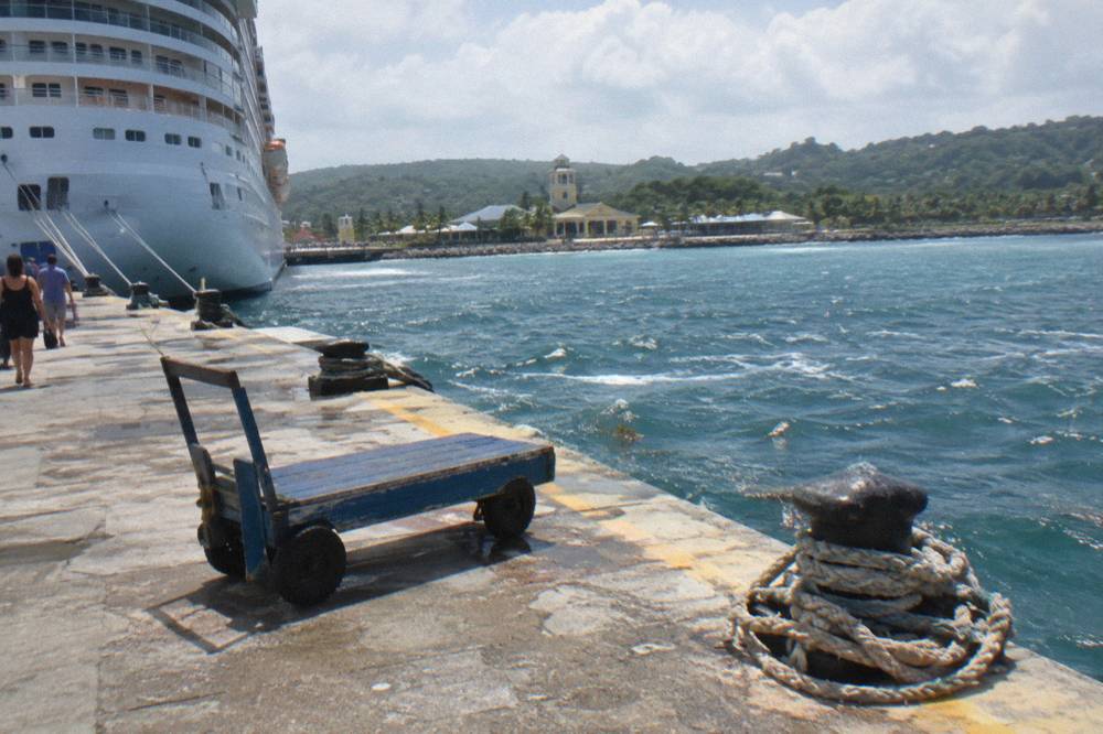 Cruise ship docked at a Caribbean port pier in morning light