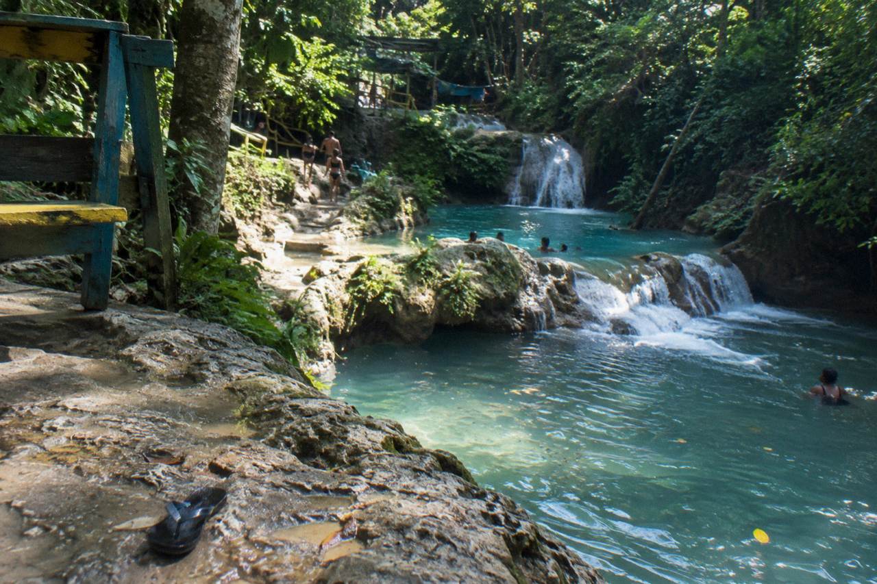 Turquoise waterfall pools surrounded by lush green forest at the Blue Hole near Ocho Rios