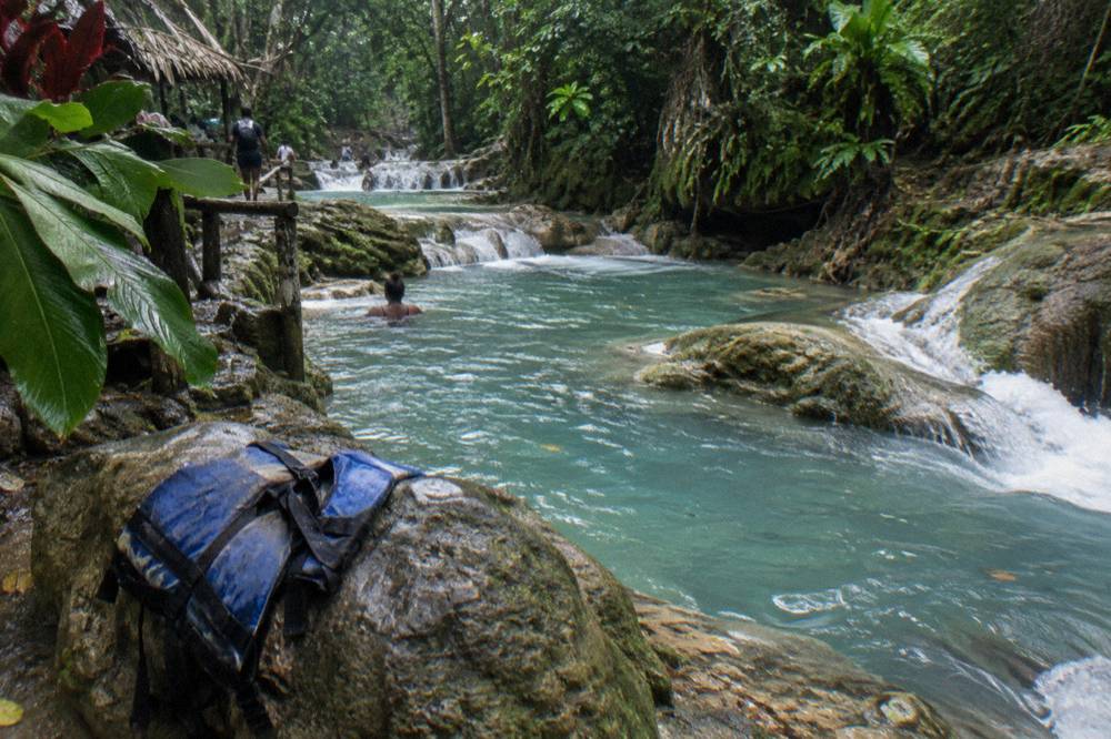 Turquoise waterfall pools surrounded by jungle foliage near Ocho Rios