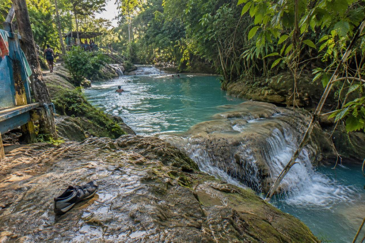 Turquoise waterfall pools ringed by jungle foliage in the hills above Ocho Rios