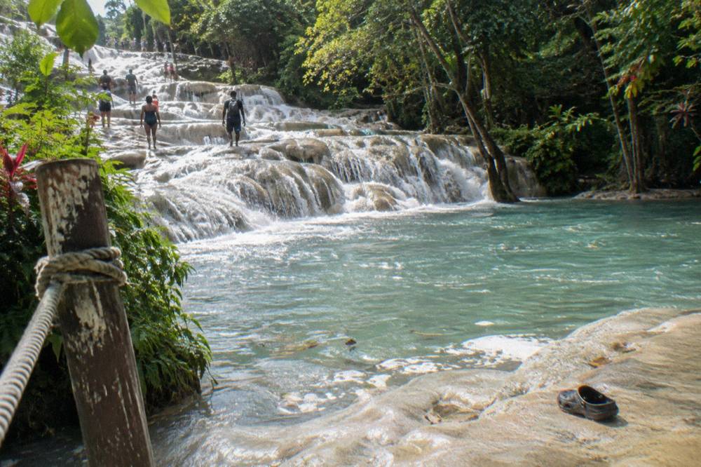 Terraced limestone steps of a wide waterfall with water spilling down a series of ledges