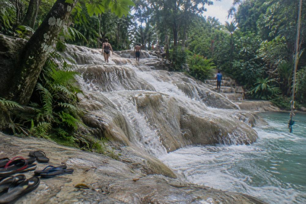 Water rushing down terraced limestone steps at a tropical waterfall