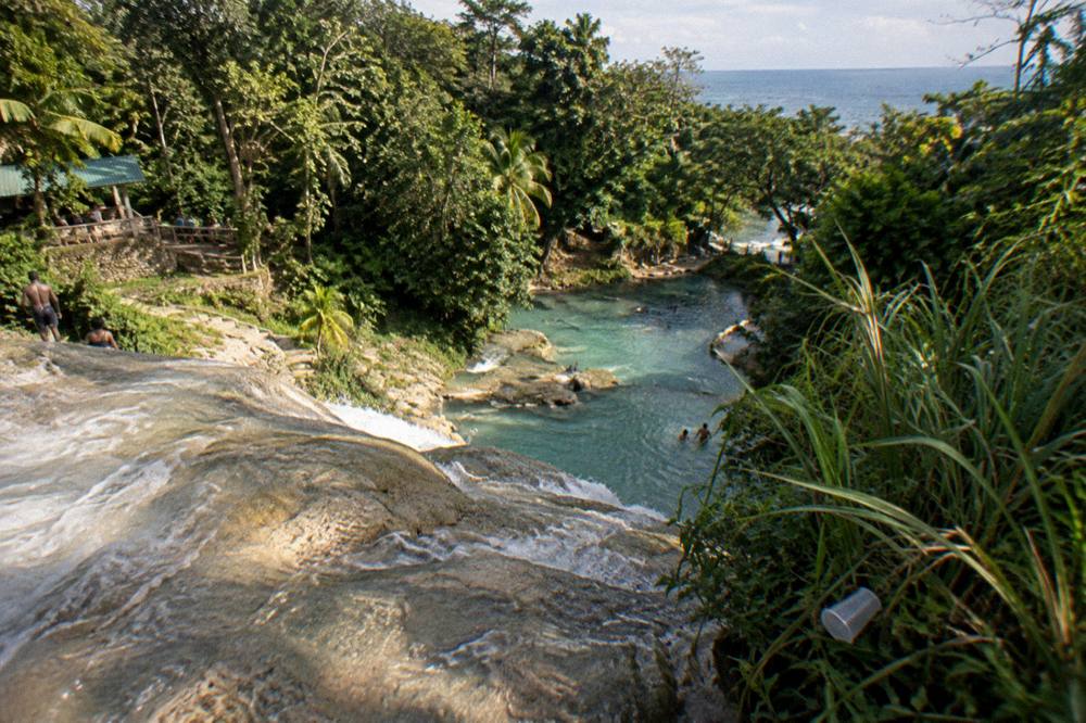 River winding through dense tropical greenery toward limestone rocks