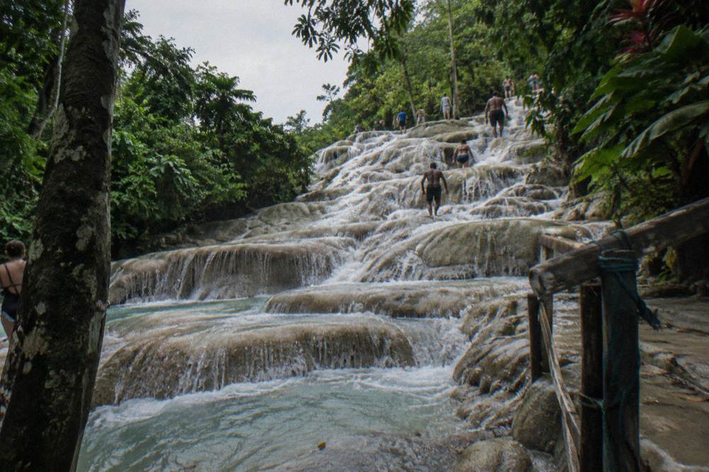 Terraced limestone waterfall with water cascading into a series of climbing pools